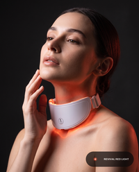 Revival Aura neck-light accessory worn around the neck, ember-red light glowing along the jawline