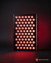 Revival Panel Blaze red light therapy panel, front-facing angle, powered on with warm ember glow