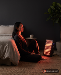Revival Panel Blaze in use, red light therapy panel powered on with warm ember glow