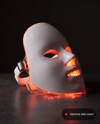 Revival Aura, 7-color LED facial mask, three-quarter angle showing strap