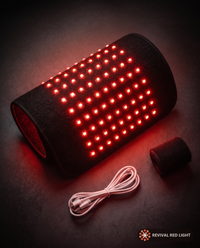 Revival Wrap red light therapy pad, alternate angle, powered on with warm ember glow